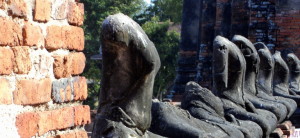 row of headless Buddhas in Thailand